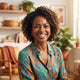 A smiling, diverse woman posing in a bright, modern room with warm amber and terracotta decor as a professional customer port